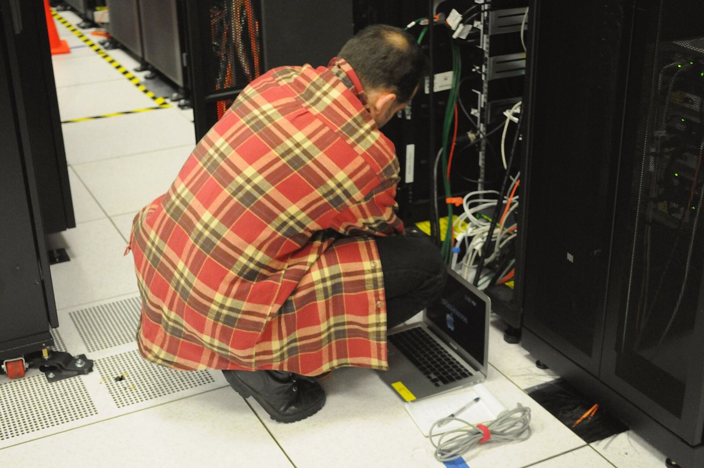 Technician working on a data center server rack